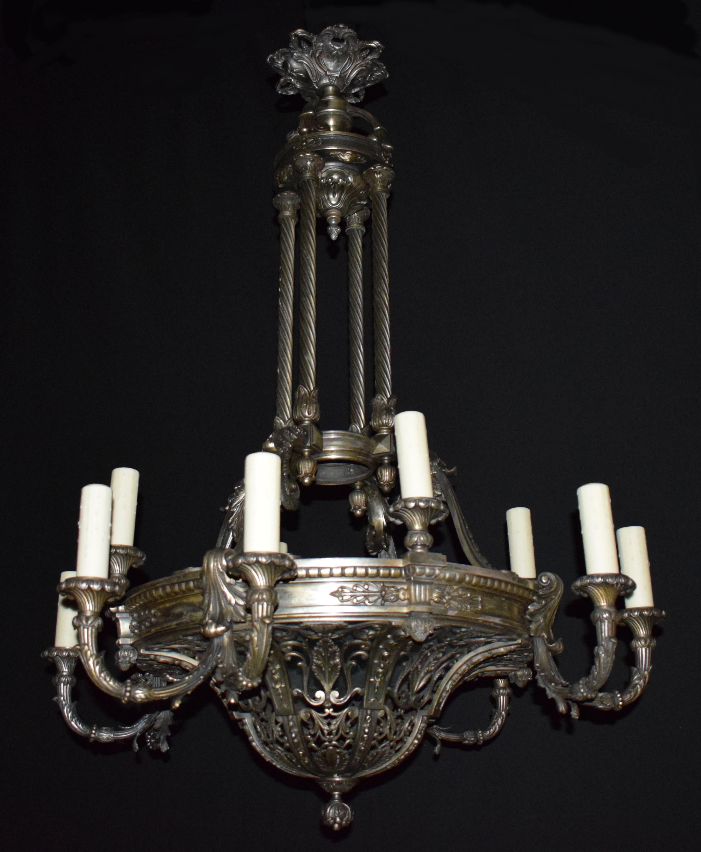 A very fine and striking silver over bronze neoclassical chandelier. The pierced bottom dome of great quality is the main feature of this fixture. The main ring issuing four pairs of reeded arms and four single lights. Supported by four twisted
