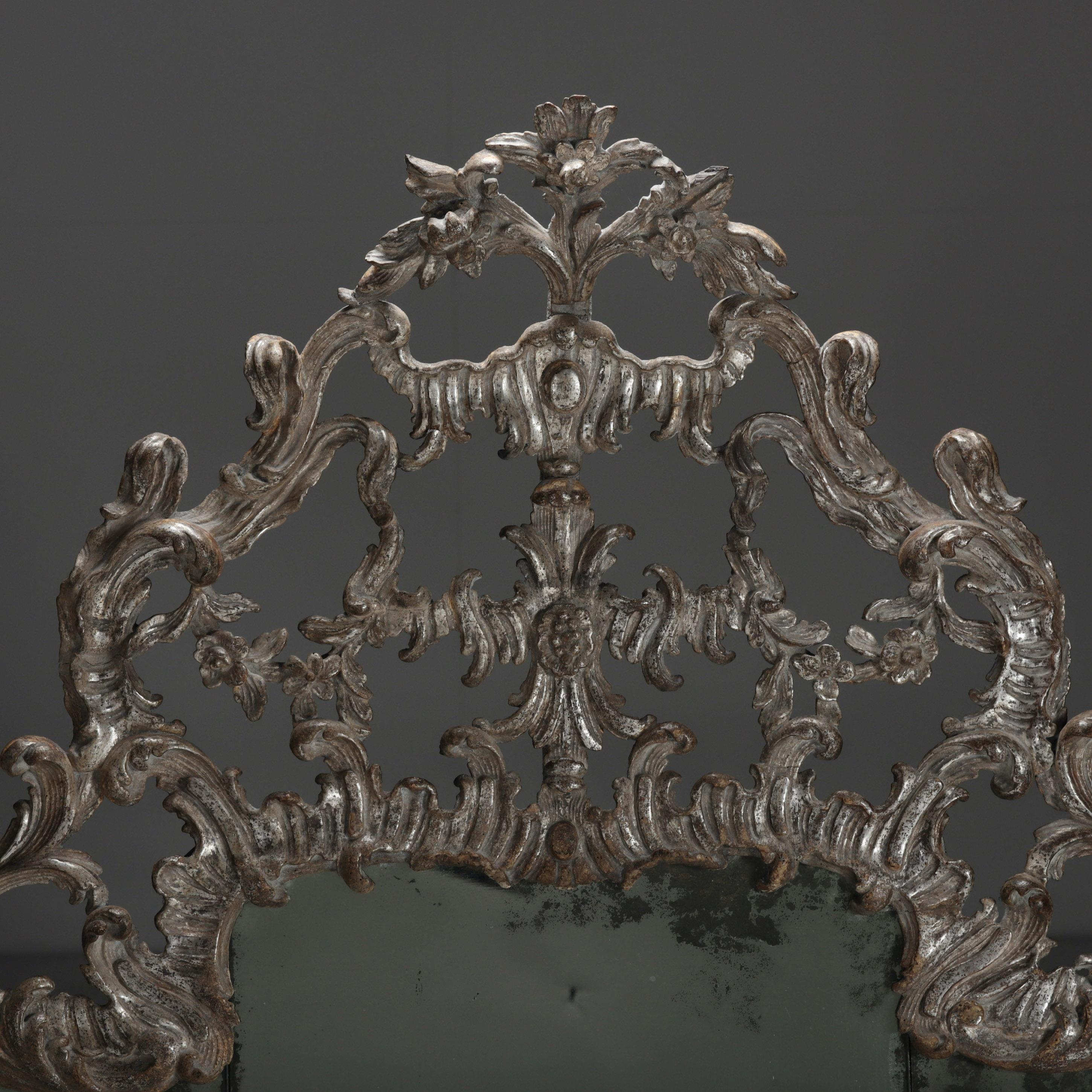 AN 18th CENTURY ITALIAN, OVERMANTEL MIRROR
With its original foxed mirror plates, lightly cleaned to reveal its original silver leaf.
