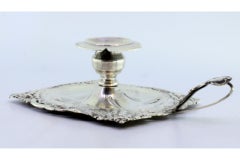 Silver paddle, cut and embossed with floral motifs
