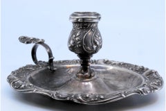 Silver paddle embossed with floral motifs