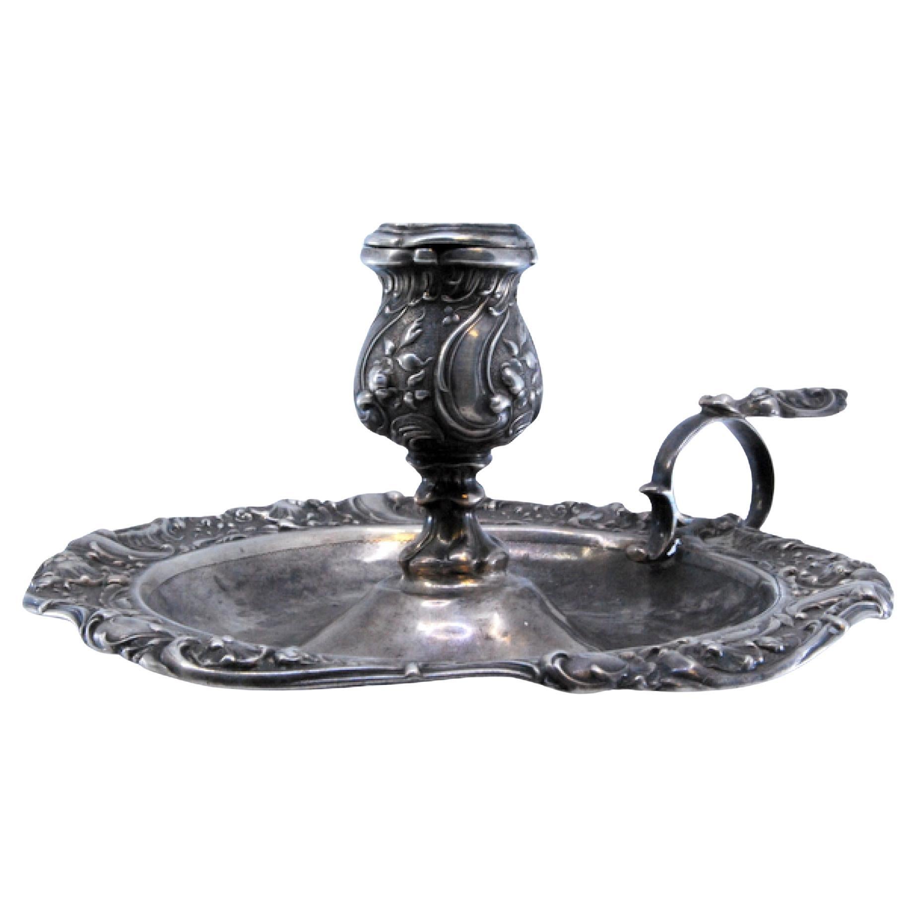 Silver paddle embossed with floral motifs