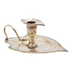 Silver paddle in the shape of a cut-out leaf