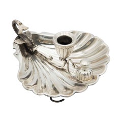 Silver paddle in the shape of a shell