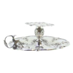 Silver paddle w/ raised floral motifs 
acanthus leaf applications on the handle