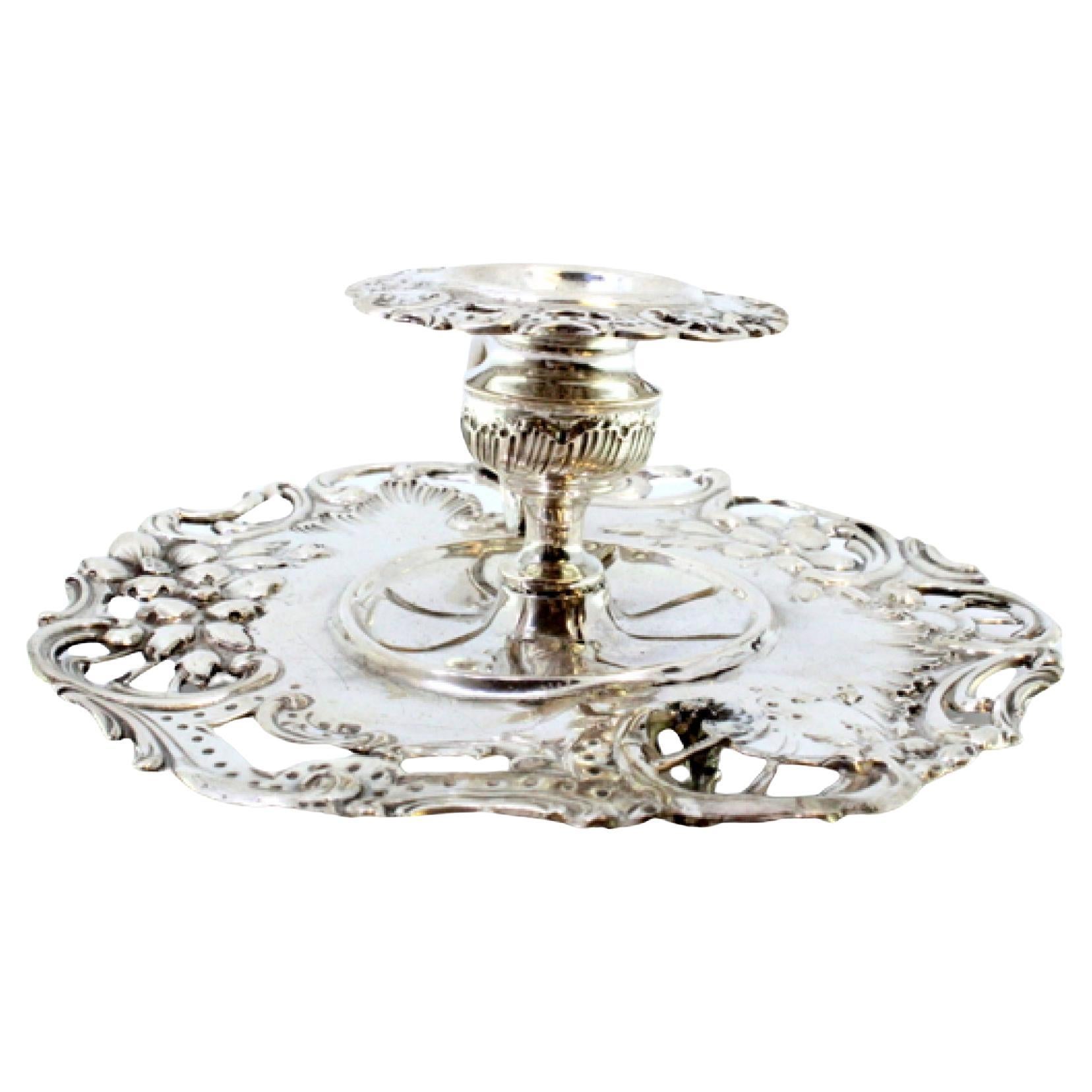 Silver paddle with a cut-out base and raised floral motifs