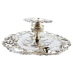 Silver paddle with a cut-out base and raised floral motifs