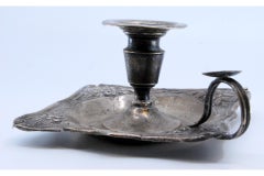 Silver paddle with a smooth center and raised edge