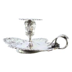 Silver paddle with embossed floral motifs and applications