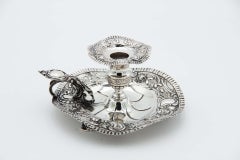 Silver paddle with embossed floral motifs