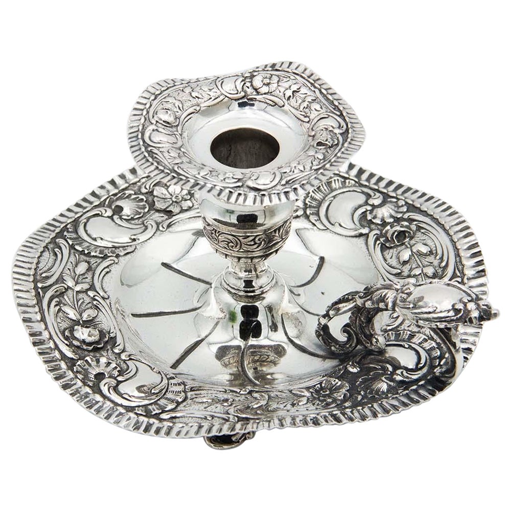 Silver paddle with embossed floral motifs