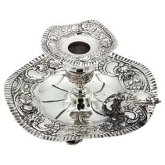 Silver paddle with embossed floral motifs
