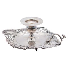 Silver paddle with embossed floral motifs