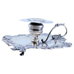 Silver paddle with embossed flowers and set on three feet