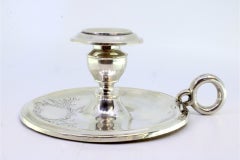 Silver paddle with engraved plant motifs surrounding a monogram card