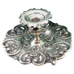 Silver paddle with floral motifs and a smooth handle