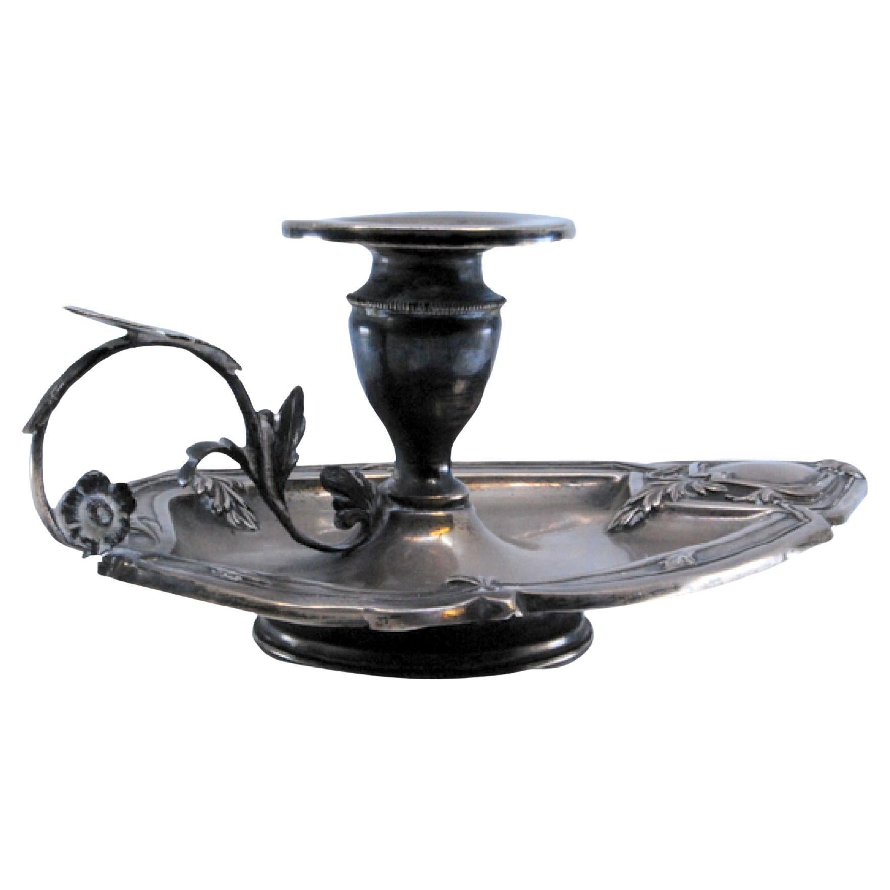 Silver paddle with floral motifs and border