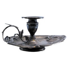 Silver paddle with floral motifs and border