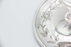 Silver paddle with floral motifs