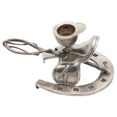 Silver paddle with horseshoe, peg and horse saddle