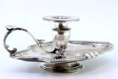 Silver paddle with pearly friezes and leaf-shaped reliefs supporting the shaft