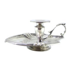 Silver paddle with pearly friezes and leaf-shaped reliefs supporting the shaft