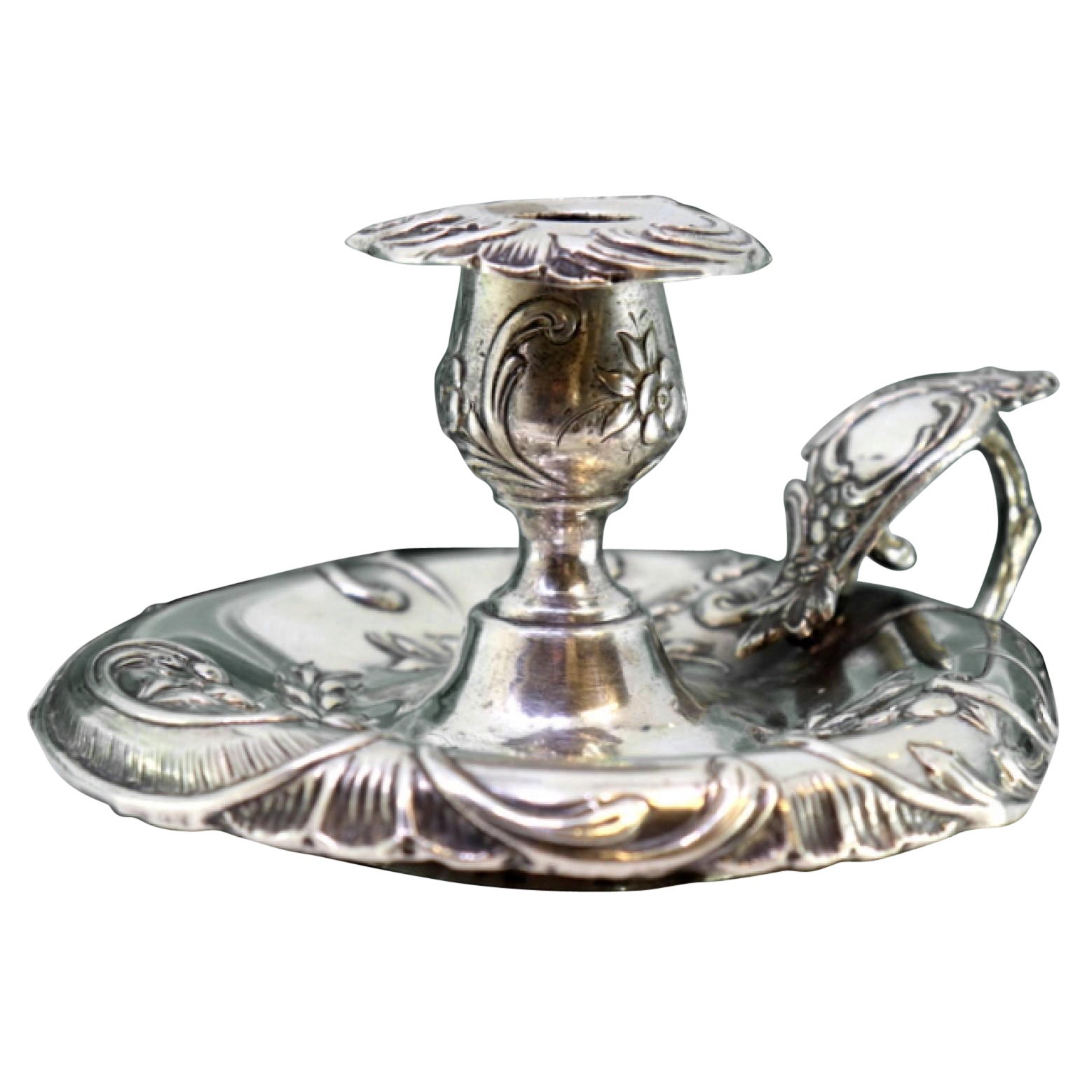 Silver paddle with raised floral motifs and monogram card