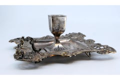 Silver paddle with raised floral motifs