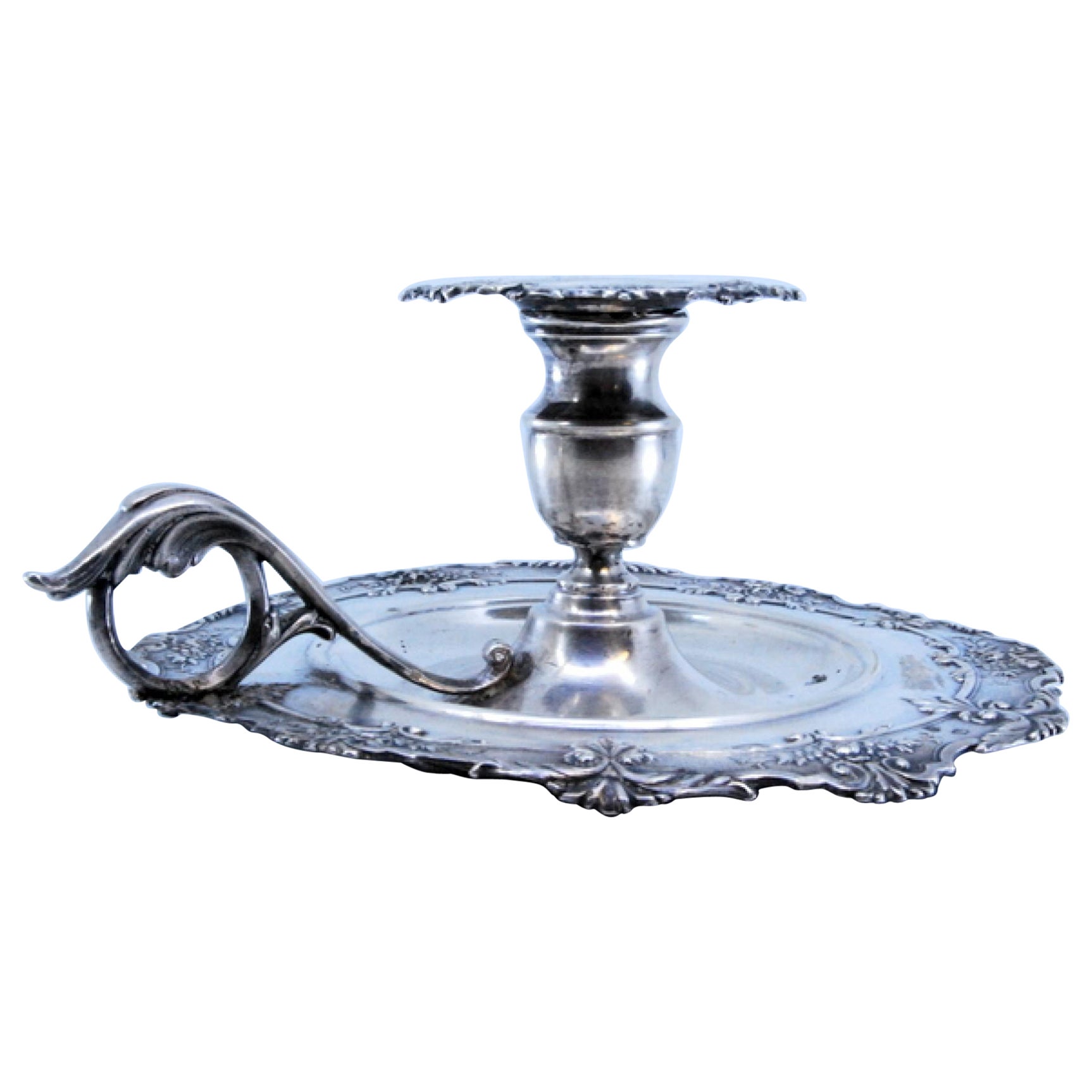 Silver paddle with raised floral motifs