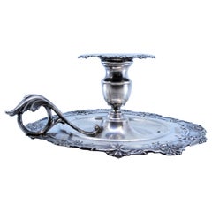 Silver paddle with raised floral motifs