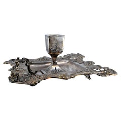 Silver paddle with raised floral motifs