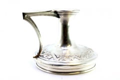 Silver paddle with raised floral motifs in the circular shape