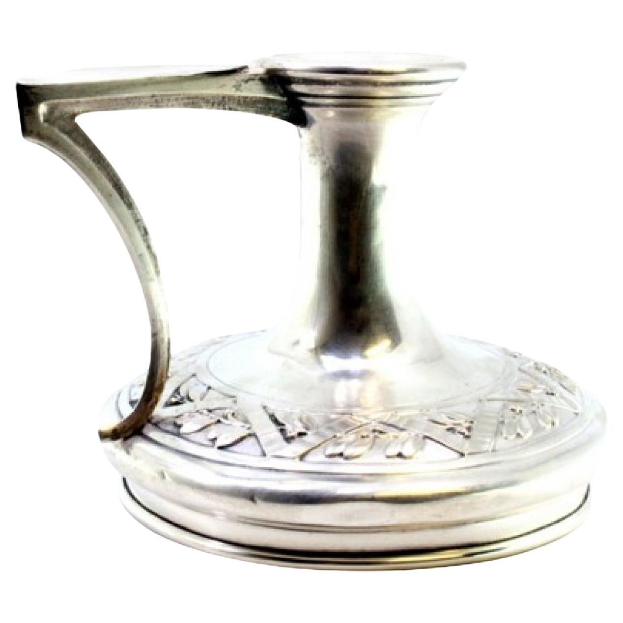 Silver paddle with raised floral motifs in the circular shape