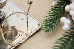 Silver paddle with raised florals, monogram card, and pocket watch holder