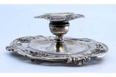 Silver paddle with relief applications and three simple feet