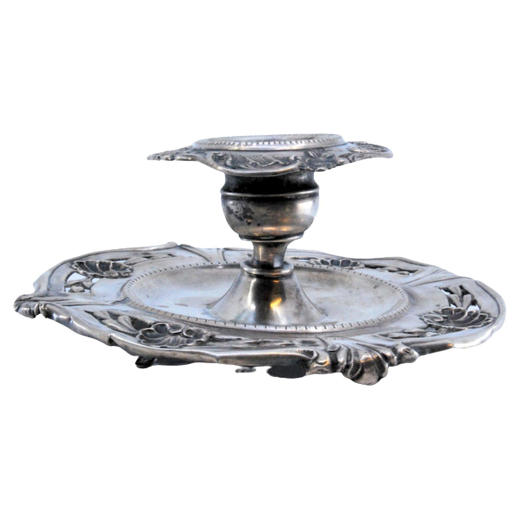 Silver paddle with relief applications and three simple feet