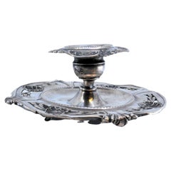 Silver paddle with relief applications and three simple feet