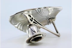 Silver paddle with relief in the center and a cut-out handle