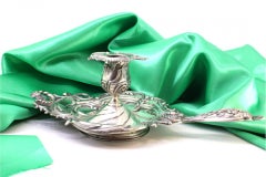 Silver paddle with reliefs, applications and cutouts