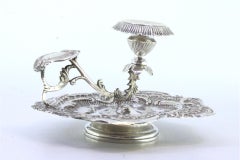 Silver paddle with reliefs, cutouts, handle applications, and acanthus leaves