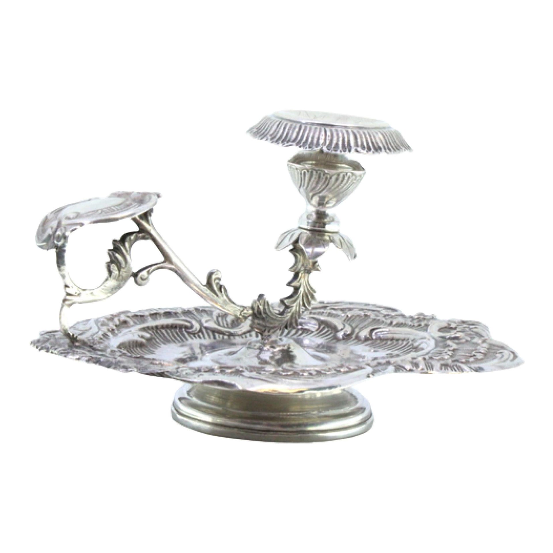 Silver paddle with reliefs, cutouts, handle applications, and acanthus leaves