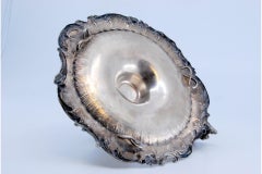 Silver paddle with shell shape and harlequin on the handle