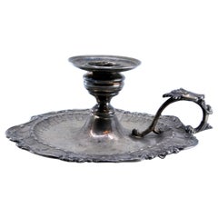 Silver paddle with shell shape and harlequin on the handle