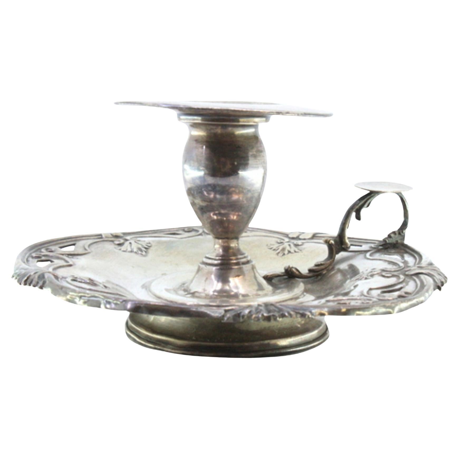 Silver paddle with trimmed edges and placed on a circular base For Sale