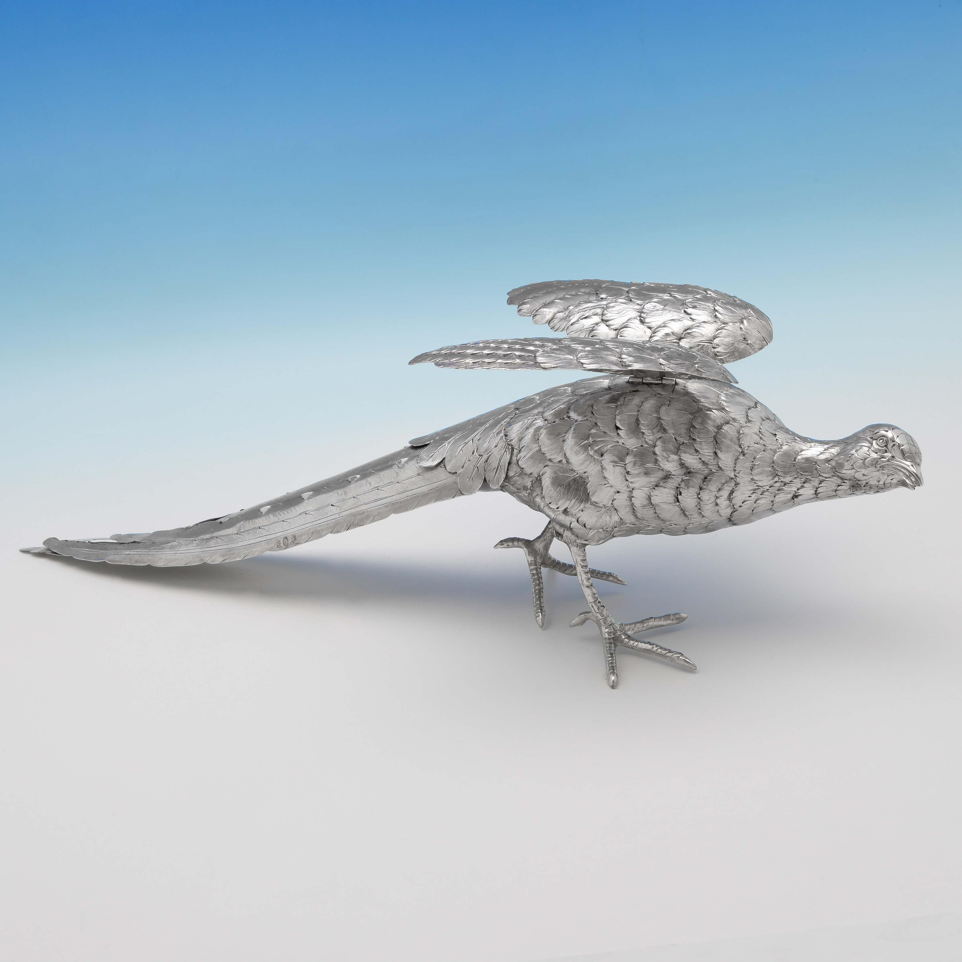 Made circa 1900, this handsome pair of antique, German silver pheasants, have very realistic feather detailing and hinged wings. The male measures 20