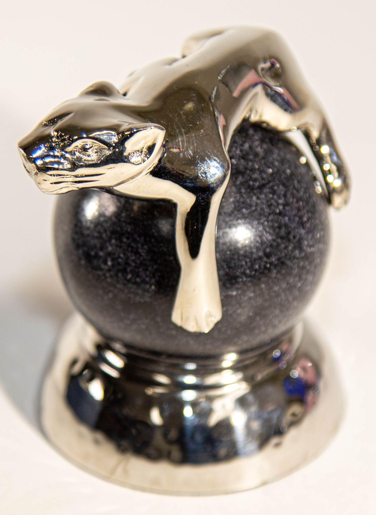 A Silver Panther Paperweight on a Black Marble Ball By: Mary Jurek Design Inc.
Mary Jurek Panther Paperweight Marble Ball and Chrome.
Designed as a panther on a black marble ball.
A preying Panthere paperweight perched on black marble.
An ideal