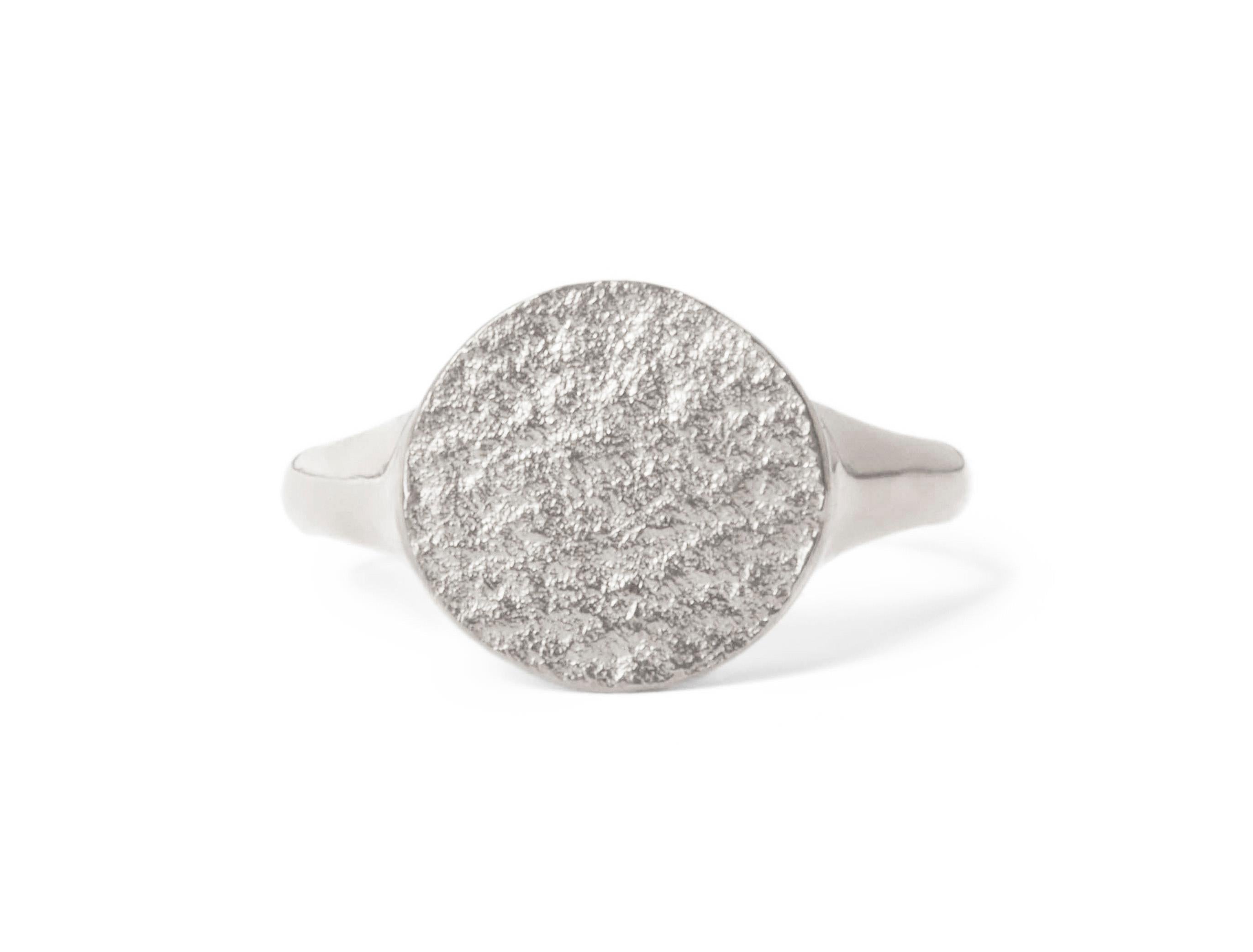 This textured signet ring crafted in solid sterling silver has a unique shimmering texture on the face and a high polish finish on the band for a comfortable fit.  Available in UK size M 1/2 (equivalent to US size 6 1/4), can be resized upon