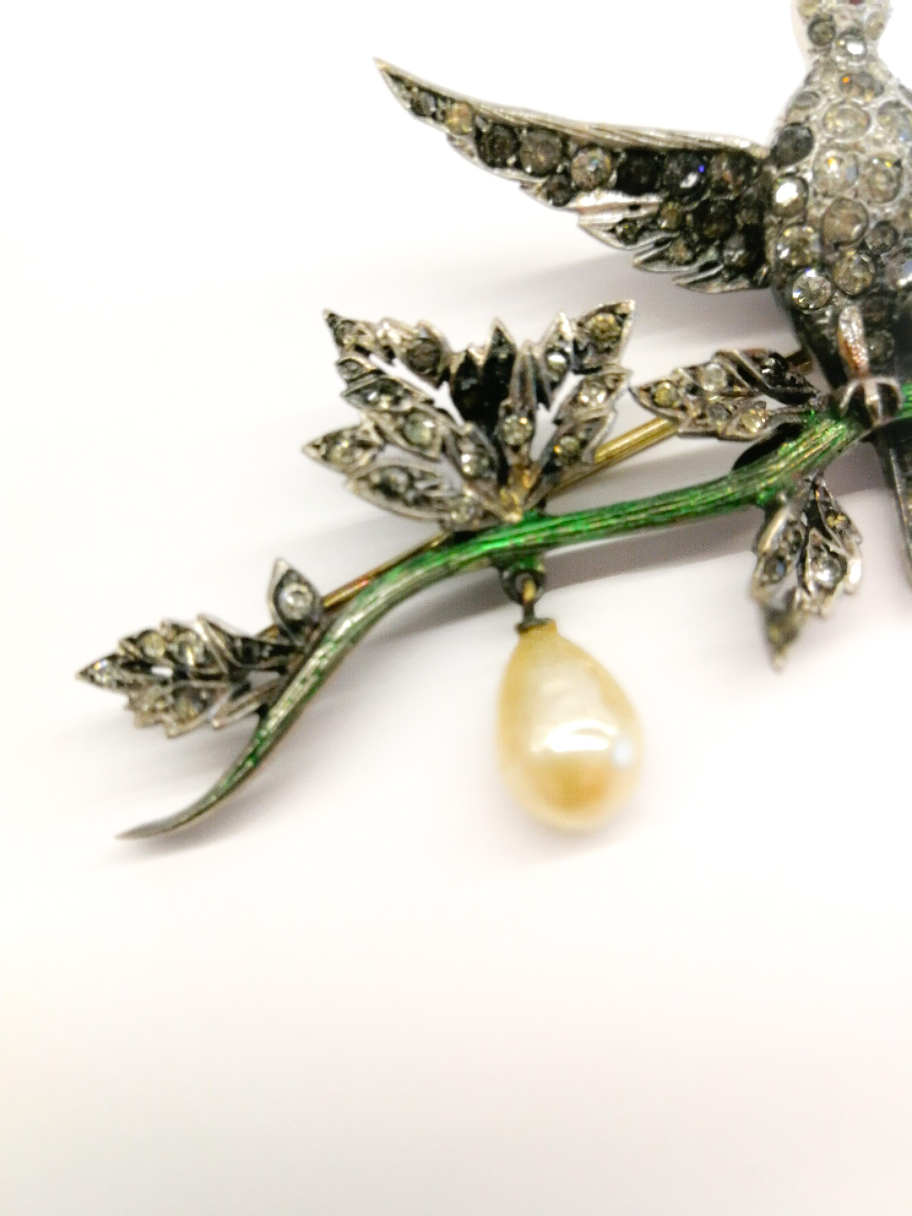 A very rare and exquisite 'en tremblant' brooch, from Christian Dior. Of excellent workmanship, the brooch is made of enamelled sterling silver, with clear and coloured pastes, and glass baroque pearl drops, the bird's wings gently 'trembling' with