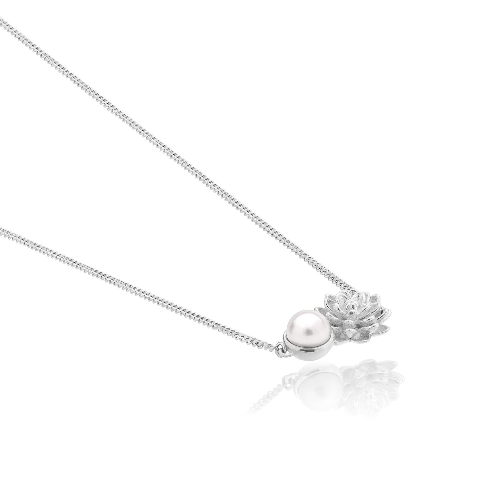 Inspired by the Dahlia, Mexico's beautiful national flower,this charm is handmade in .925 silver and includes a white pearl.Inspired by the Dahlia, Mexico’s beautiful national flower, this collection is presented in full Bloom with all the crowned