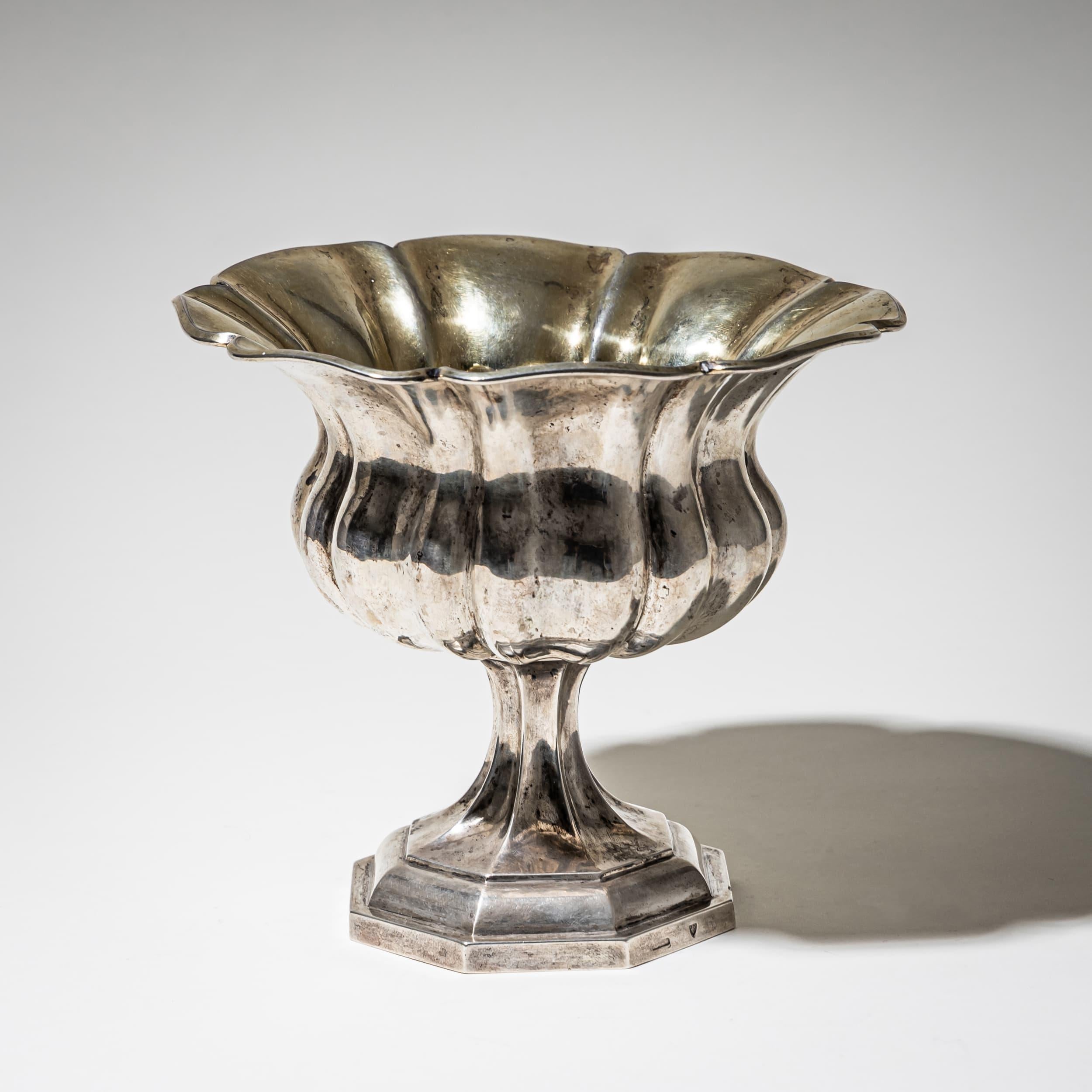 Elegante coupe sur piédestal de forme tulipe, avec un corps à godrons et une base octogonale. Un bel exemple d'orfèvrerie sud-allemande du XIXe siècle. La base porte la marque de la ville de Munich, la date de 1843 et la marque de Joseph II.