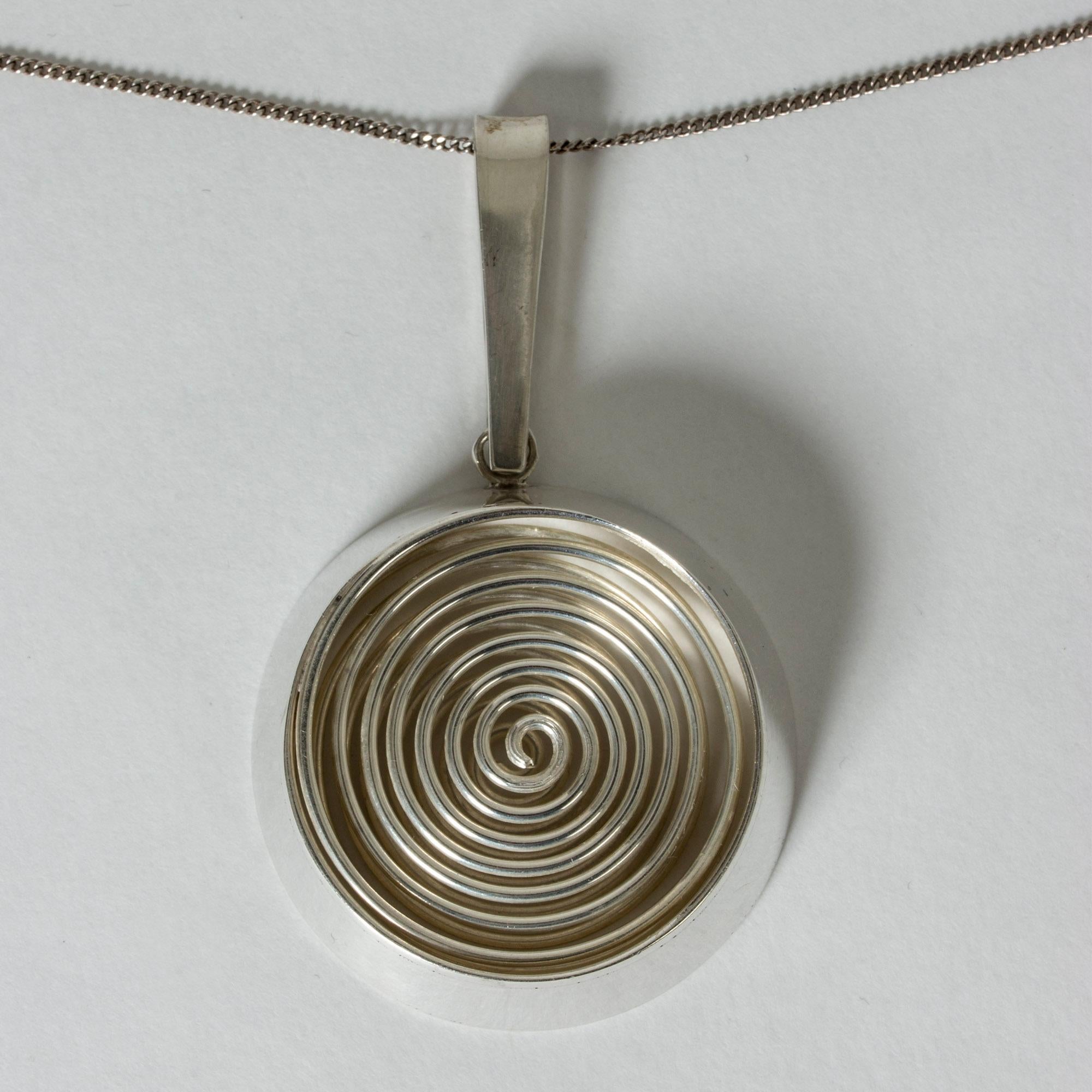 Striking silver pendant from Kaplans, with a springy spiral inside. Hypnotic design with great execution.